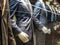 Men Suits, with shirts, ties, pants and blue jackets on display on dummies in front of a tailor store, on a window.