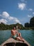 Men in swim short on longtail boat in Krabi Thailand, guy on vacation Railay beach Ao Nang krabi