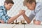 Men at the table and armwrestling