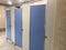 Men Toilet cubicles Beige color wall partition and Blue color attractive doors coming in ready made from the industry and which is