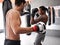 Men, training for boxing and fitness, sport and coaching with athlete and personal trainer for workout in gym. Exercise