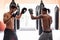 Men, training for boxing in gym and exercise, sport and coaching with athlete and personal trainer for workout. Fitness