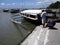 Men tries to catch fish using a fishing pole at the Binangonan Fish Port and Terminal