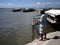 Men tries to catch fish using a fishing pole at the Binangonan Fish Port and Terminal