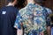 Men with tropical floral shirt and staff black t-shirt before Les Hommes fashion show, Milan Fashion Week street