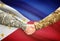 Men in uniform shaking hands with flag on background - Philippines