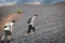 Men walks on stones slope