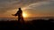 Men warrior monk practicing silhouette tai chi karate kung Fu on the rocky stones horizon at sunset or sunrise. Art of