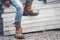 Men wear construction Boots safety footwear for worker at construction site. Engineer Wear Jeans Brown Boots Worker on Background