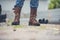 Men wear construction Boots safety footwear for worker at construction site. Engineer Wear Jeans Brown Boots Worker on Background