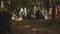 Men wears camouflage and protective mask while participating in a paintball battle game with friends