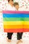 Men were happy together over rose background holding rainbow flag .  LGBT gay couple love concept