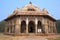 Men in white dresses walking at Isa Khan Niyazi tomb, Humayun\'s