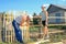 Men and a woman, a daughter with a father, make a picket fence around a summer cottage