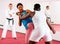 Men and woman training self-protection martial arts in gym