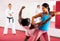 Men and woman training self-protection martial arts in gym