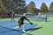 Men and Women in a Doubles Game of Pickleball