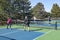 Men and Women in a Doubles Game of Pickleball