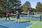 Men and Women at the Net in a Doubles Game of Pickleball