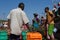 Men and women are preparing to unload the fishing vessel. A small fishing port in southern India. India, Karnataka, 2017