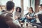 Men and women sitting in a circle during group therapy, adhesive notes on forehead