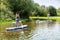 Men and women stand up paddleboarding