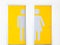 Men and women symbols on yellow public toilet entrance doors.