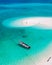 men and women walking on a sandbar in the ocean of Koh lipe Southern Thailand during vacation