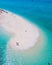 men and women walking on a sandbar in the ocean of Koh lipe Southern Thailand during vacation