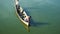 Men on wooden boat fishing at Taung Tha Man lake near U Bein bridge. Myammar