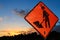 `Men at work` / roadwork sign at sunset