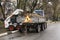 Men at work. Work on the collection of autumn leaves on the streets. Cleaning leaves