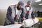 Men workers packing carpet in a plastic bag after cleaning it in automatic washing machine and dryer in the Laundry