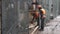 Men workers wearing uniform and helmet stand outside at construction area.