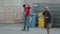 Men working in construction, uncoiling cable at building site. Manual labor