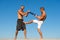 Men with yoga mat captured in motion blue sky background. Sportsman fighting. Practice fighting skills outdoor. Improve