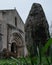 A menhir in front of a door of a church