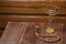 Menorah and beautiful rosary on a wooden table on a wooden wall