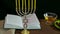 A menorah with candles and a festive prayer book on Rosh Hashanah.