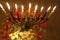 Menorah with candles flowers and chocolate coins Hanukkah and Judaic holiday symbol