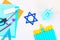 Menorah, dreidel, sevivon, the star of David with their own hands on a white wooden table. DIY for a child. Celebration of Chanuka