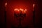 A menorah filled with lit candles and flanked by two single candles for the Jewish holiday, Hanukkah.