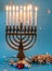 Menorah with nine burning candles, dreidels, and chocolate. Hanukkah.