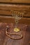 Menorah and rosary on a wooden table on a wooden wall