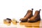 Mens Brogues Boots In Line With Cleaning Accessories on Shiny Table