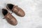 Mens brown leather walking shoes on textured background, top view with copy space