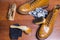 Mens Footwear Conceots. Closeup of Tan Male Derby Boots With Cleaning Accessories and Wax In Front