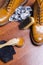 Mens Footwear Conceots. Closeup of Tan Male Derby Boots With Cleaning Accessories and Wax In Front