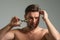 Mens hairstyle, haircut. Middle aged man with scissors cut hair. Mens haircare, beauty barber concept. Bearded man, with