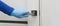 Mens hand in a blue protective gloves opens or close the door. Antibacterial prophylaxis banner in times of viruses and